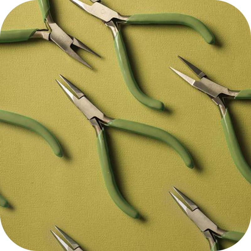 Jewellery Maker tools laid out on green background